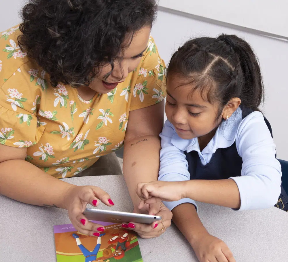 adult and child reading on tablet