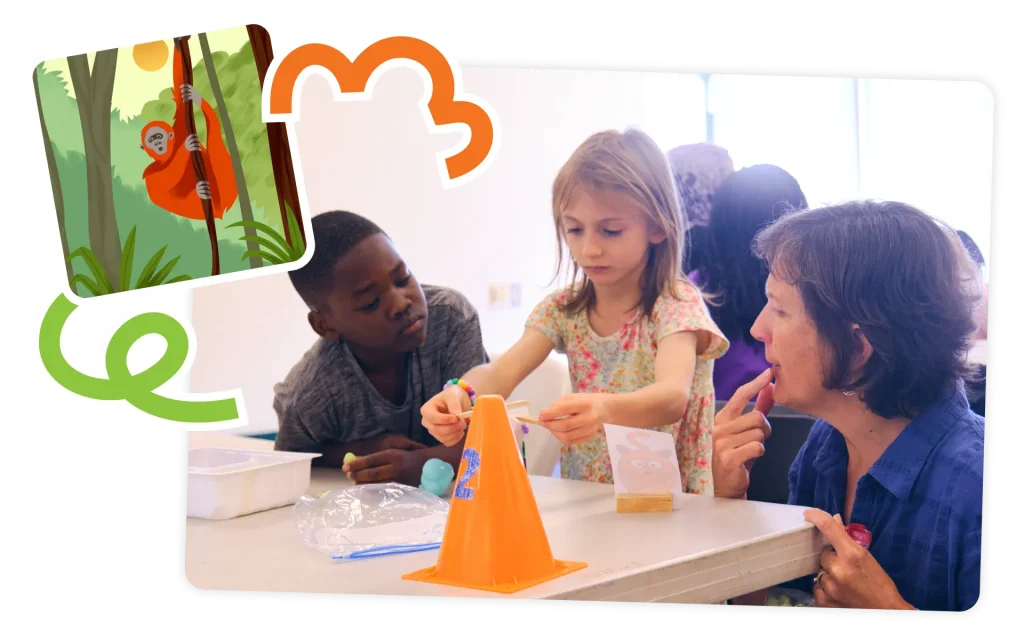 A science teacher and two children, one boy and one girl, are engaged in a craft activity using an orange cone and paint in a brightly-lit classroom.