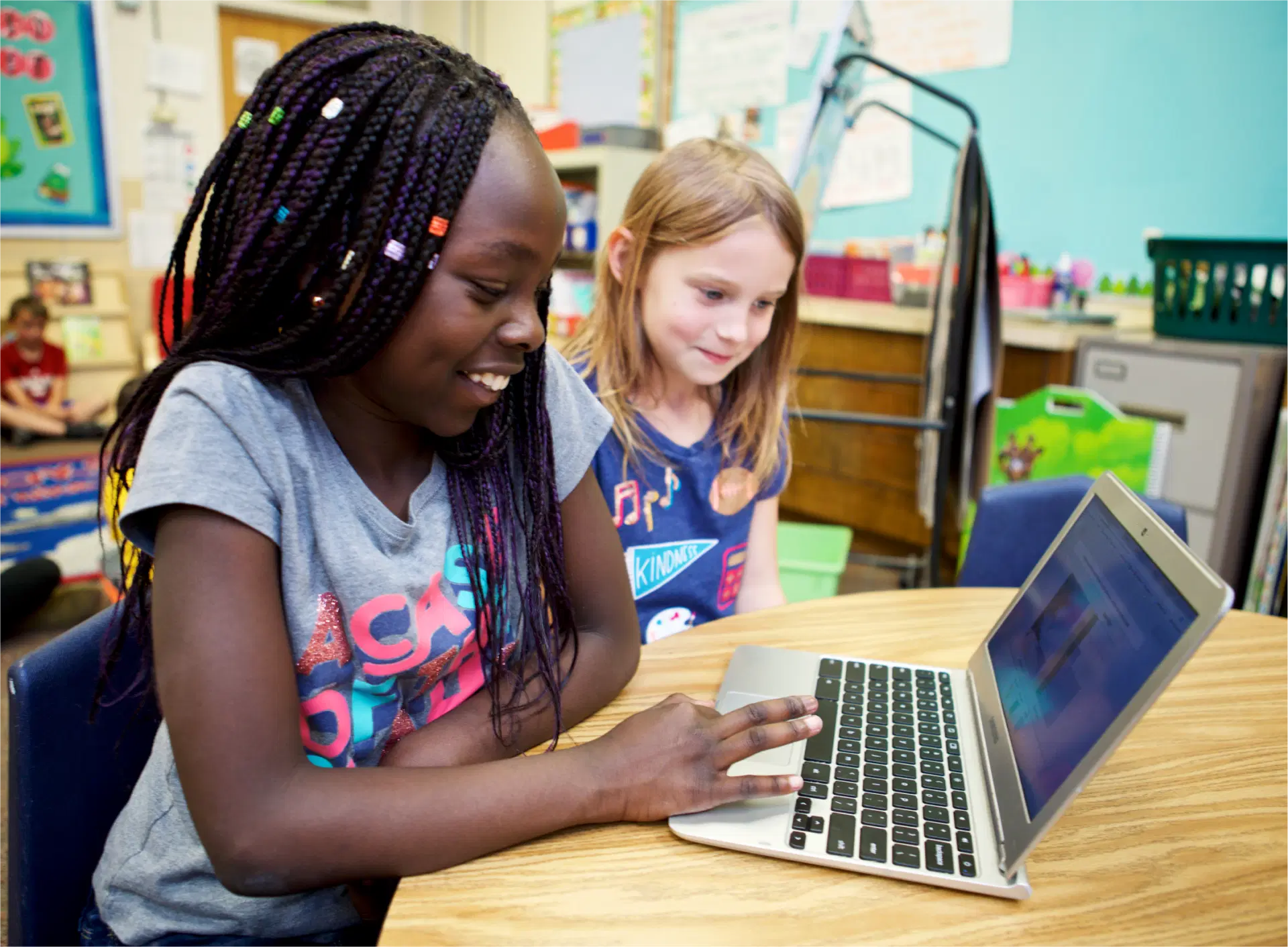 Two girls in elementary school are using Amplify Science on a laptop