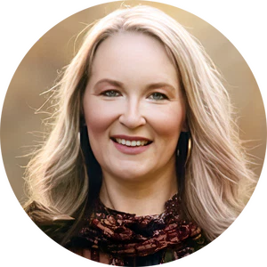 A person with long blonde hair, wearing a lace scarf, smiles in a sunlit outdoor setting, reminiscent of the excitement Pennsylvania teachers bring to Amplify Science programs for elementary students.