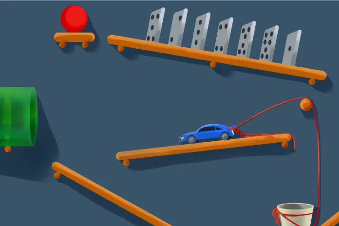 Un artilugio complejo presenta fichas de dominó apiladas, una bola roja sobre una pequeña plataforma, un auto de juguete azul atado a una cuerda y un tubo verde, todo interconectado por rampas de madera.