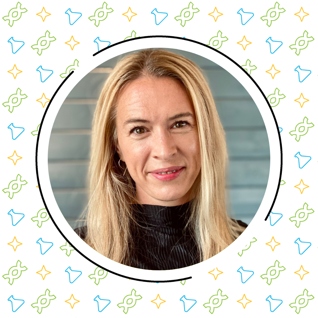 Portrait of a smiling middle-aged woman with long blonde hair, wearing a black top, surrounded by a frame with colorful star and science connections icons.