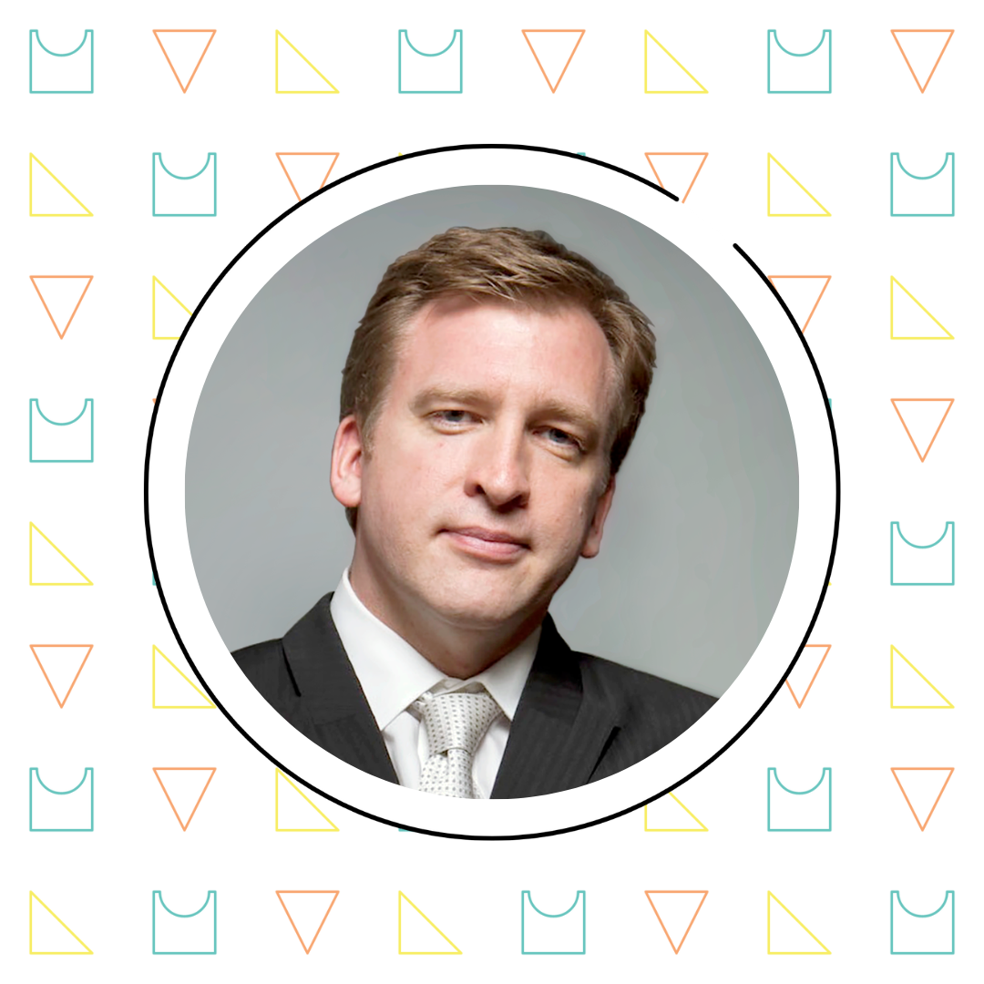 Portrait of a man in a suit with a white shirt and tie, framed by a decorative border featuring geometric patterns inspired by Jason Zimba's math fluency concepts.