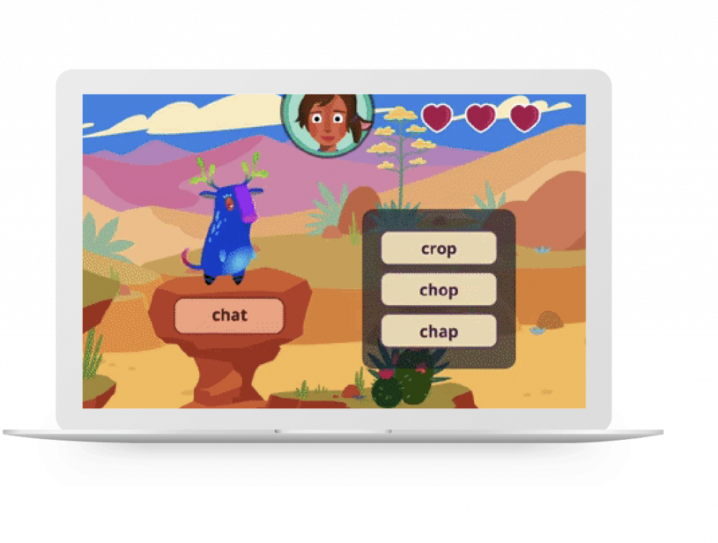 A laptop screen displaying a literacy intervention game with a cartoon llama in a desert setting and a word selection task presented to a child’s avatar in the corner.