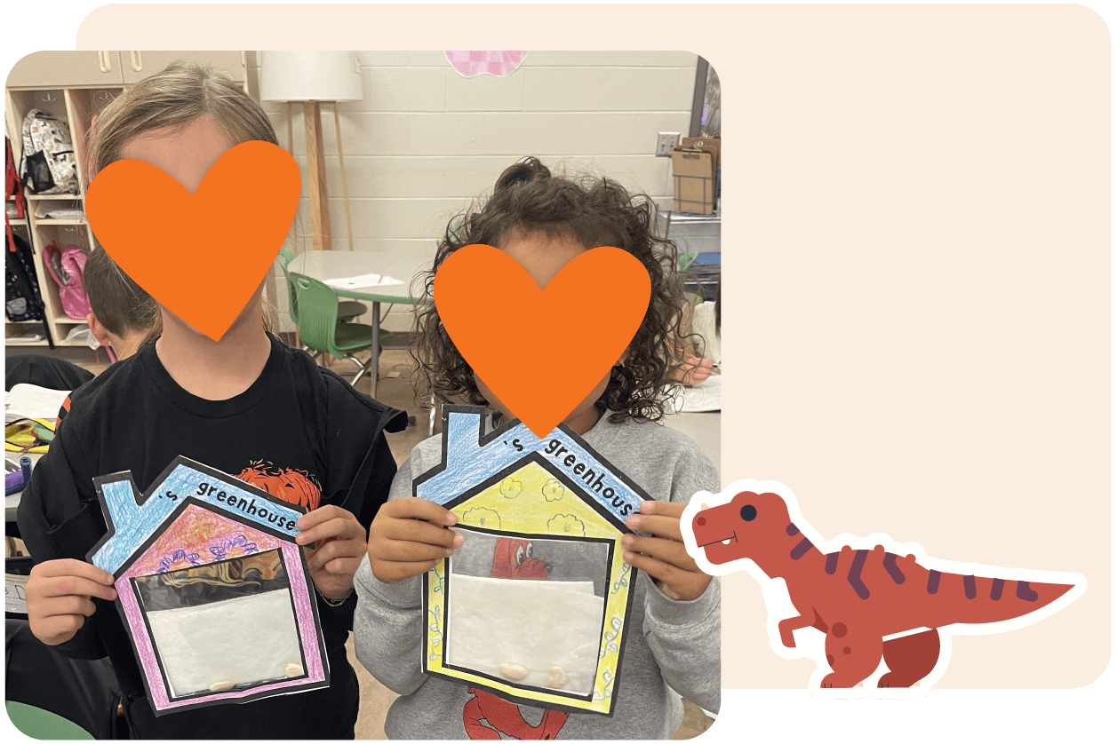 Two children holding paper greenhouses with seeds inside. Their faces are covered with orange hearts. A cartoon dinosaur is in the corner. Classroom setting in the background.