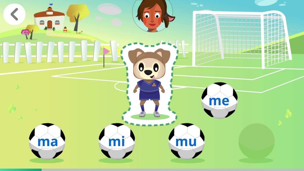 Educational game screen showing a cartoon character in a soccer field. Four soccer balls display the syllables "ma," "mi," "mu," and "me." A face icon appears above the scene.