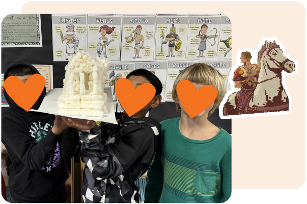 Three children hold a model of an ancient Greek temple in front of a classroom display about Roman gods with educational posters, using Amplify CKLA resources for teachers. Faces are covered with orange heart shapes.