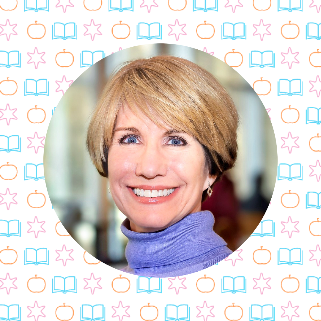 A woman with short blonde hair and a purple turtleneck smiles at the camera; the background, featuring books, apples, and stars, hints at her passion for teaching resources and creative classroom challenges.