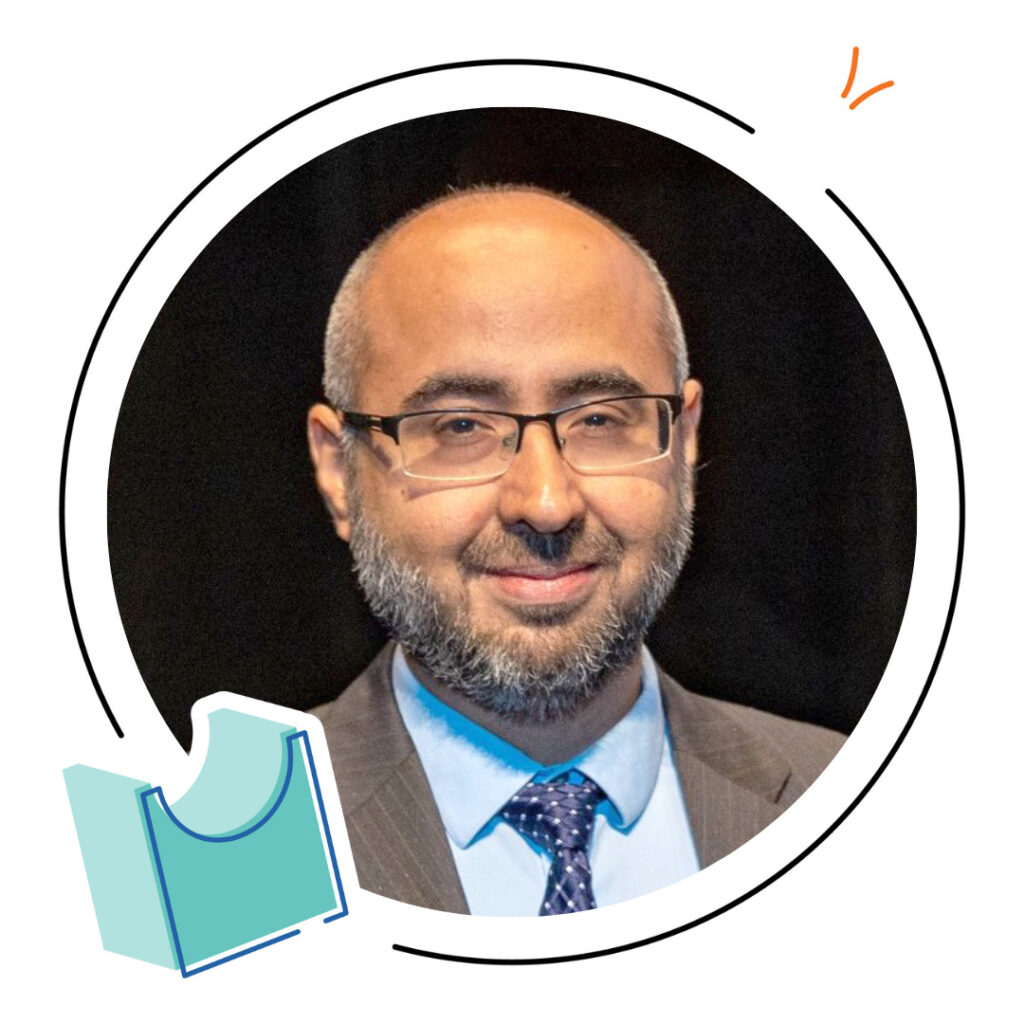 A man with glasses, a beard, and a receding hairline wearing a suit and tie, pictured inside a circular frame with simple graphic accents—perfect for representing math teacher resources or the math teacher lounge.