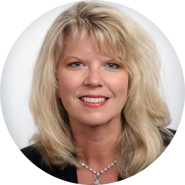 A woman with shoulder-length blonde hair, wearing a black blazer and a silver necklace, smiles at the camera against a light background.