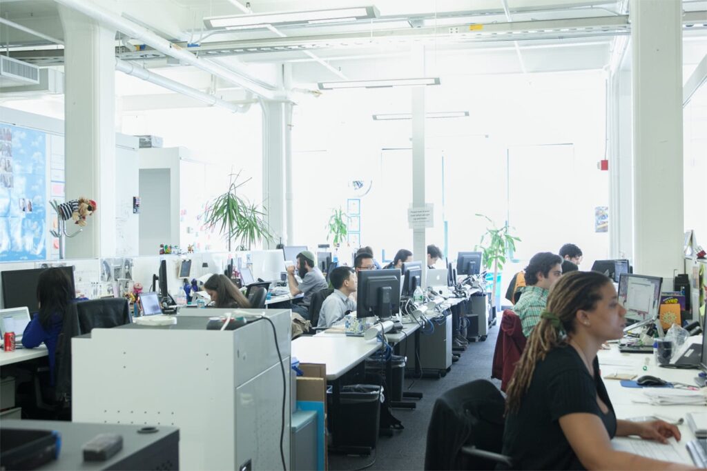 People sit at desks in an office