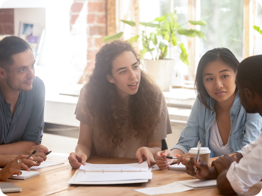 A group of people sitting around a table.