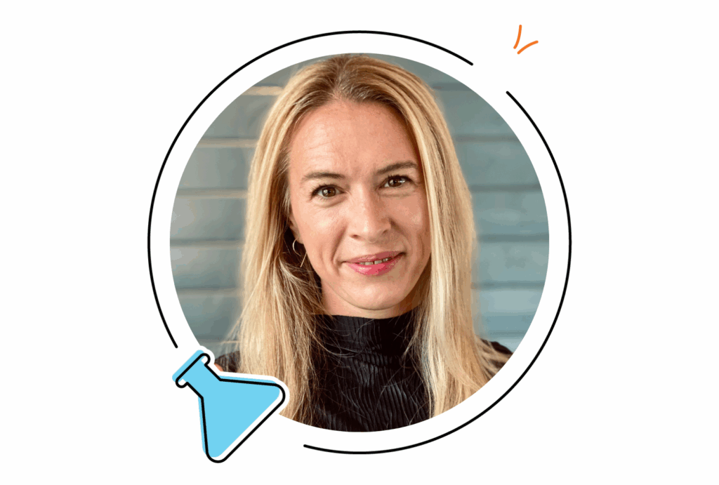 A woman with long blonde hair and a black top is shown in front of a blue background, framed by a circular graphic with an illustrated flask in the corner.